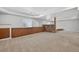 Finished basement with built-in cabinets, a stone accent wall, and plush carpeting for added comfort at 14620 Prairie Sky Ln, Broomfield, CO 80023