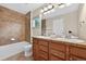 Bathroom features double sinks, a bath tub, and a big mirror with modern vanity lighting at 14620 Prairie Sky Ln, Broomfield, CO 80023