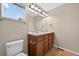 The bathroom features double sinks with a vanity and modern lighting fixtures over a large mirror at 14620 Prairie Sky Ln, Broomfield, CO 80023