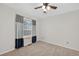 A bedroom with carpet and a window with blue curtains provides a cozy, neutral space at 14620 Prairie Sky Ln, Broomfield, CO 80023