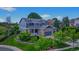 Charming two-story home featuring a stone facade, three-car garage, covered porch, and beautifully landscaped front yard at 14620 Prairie Sky Ln, Broomfield, CO 80023