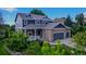 Charming two-story home featuring a stone facade, three-car garage, covered porch and lush landscaping at 14620 Prairie Sky Ln, Broomfield, CO 80023