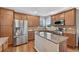 Bright kitchen with stainless appliances, granite counters, an island, and beautiful wood cabinets at 14620 Prairie Sky Ln, Broomfield, CO 80023