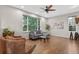 Bright living room with beautiful hardwood floors, a ceiling fan, and plenty of natural light at 14620 Prairie Sky Ln, Broomfield, CO 80023