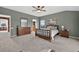 The main bedroom features neutral tones, a large bed, and two windows for natural light at 14620 Prairie Sky Ln, Broomfield, CO 80023