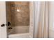 Modern bathroom features a soaking tub with tile surround and bronze fixtures at 6895 Big Horn Trl, Littleton, CO 80125