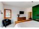 Bright bedroom with a white and dark green wall, wooden furnishings, a ceiling fan, and natural lighting at 6895 Big Horn Trl, Littleton, CO 80125