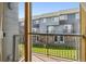 Private balcony with metal railing offering views of the community's townhomes and landscaping at 8751 Pearl St # J3, Thornton, CO 80229
