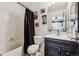 Well-lit bathroom featuring a bathtub, shower, vanity, and unique London-themed artwork at 8751 Pearl St # J3, Thornton, CO 80229