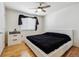 Bright bedroom features a ceiling fan, hardwood floors, and a large window at 8751 Pearl St # J3, Thornton, CO 80229