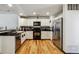 Modern kitchen featuring stainless steel appliances and hardwood floors at 8751 Pearl St # J3, Thornton, CO 80229