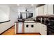 Kitchen with black granite countertops, white cabinets, and stainless steel dishwasher, ideal for a modern home at 8751 Pearl St # J3, Thornton, CO 80229