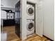 Convenient laundry closet with stacked washer and dryer on hardwood floors in this home at 8751 Pearl St # J3, Thornton, CO 80229