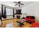 Cozy living room with a fireplace, hardwood floors, and modern decor, offering a comfortable and inviting living space at 8751 Pearl St # J3, Thornton, CO 80229