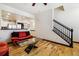 Bright living area with hardwood floors, an open floor plan, and stairs to the second level at 8751 Pearl St # J3, Thornton, CO 80229