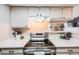 Bright kitchen with stainless steel appliances, white cabinetry, and modern finishes for cooking at 4400 S Quebec St # 107, Denver, CO 80237