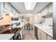 Cozy kitchen boasts stainless steel appliances, bright lighting, and dining area at 4400 S Quebec St # 107, Denver, CO 80237