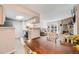 Open-concept living area with stone fireplace, adjacent kitchen, and outside patio access at 4400 S Quebec St # 107, Denver, CO 80237