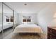 Serene main bedroom features a mirrored closet, large window, and cozy queen bed at 4400 S Quebec St # 107, Denver, CO 80237