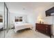 Comfortable main bedroom with closet, large window, and furnished with a wooden dresser at 4400 S Quebec St # 107, Denver, CO 80237