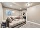 Finished basement offers a sectional couch and extra space at 8036 E 53Rd Dr, Denver, CO 80238