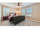 Spacious bedroom with a large bed, ample natural light, and ceiling fan at 8036 E 53Rd Dr, Denver, CO 80238