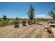 Relaxing community deck with wooden picnic tables and lounge chairs at 8036 E 53Rd Dr, Denver, CO 80238
