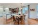 Dining area with a wooden table and leather chairs, adjacent to kitchen at 8036 E 53Rd Dr, Denver, CO 80238