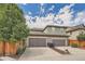 Two-car garage with driveway and landscaping at 8036 E 53Rd Dr, Denver, CO 80238