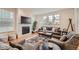Cozy living room features a fireplace, comfortable seating, and large windows at 8036 E 53Rd Dr, Denver, CO 80238