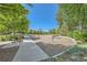 Playground with various play equipment, surrounded by trees at 8036 E 53Rd Dr, Denver, CO 80238