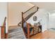 Elegant staircase with a wooden railing and carpeted steps at 8036 E 53Rd Dr, Denver, CO 80238