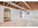 Unfinished basement with concrete floor, white walls and exposed ceiling at 1683 Monroe St, Strasburg, CO 80136