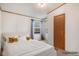 Bedroom with white carpet, gold pillows and natural light coming in at 1683 Monroe St, Strasburg, CO 80136