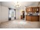 Cozy dining area with large window and adjacent kitchen featuring wood cabinets at 1683 Monroe St, Strasburg, CO 80136
