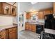Functional kitchen with black appliances, wood cabinets, and solid surface countertops at 1683 Monroe St, Strasburg, CO 80136