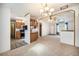 Bright living room features an open floor plan, skylight, and easy access to the kitchen at 1683 Monroe St, Strasburg, CO 80136