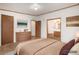 Serene primary bedroom featuring wood floors, neutral decor, and ensuite bathroom access at 1683 Monroe St, Strasburg, CO 80136