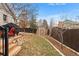 Landscaped backyard with a storage shed, lawn area, trees, and wooden stairs to an outdoor patio space at 2687 E 124Th Pl, Thornton, CO 80241