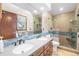 Bathroom featuring dual sinks, modern fixtures, granite countertops, and a large glass enclosed shower at 2687 E 124Th Pl, Thornton, CO 80241
