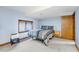 Bedroom with a large window, neutral carpet, blue walls, and a full bed with a patterned quilt at 2687 E 124Th Pl, Thornton, CO 80241