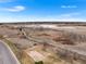 Aerial shot of a winding walking path near a horse arena, pond, and neighborhoods at 2687 E 124Th Pl, Thornton, CO 80241