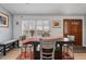 Cozy dining area with a rustic table, hardwood floors, and lots of natural light and a front door at 2687 E 124Th Pl, Thornton, CO 80241