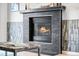 Cozy living room features a modern fireplace with unique tile accents at 2687 E 124Th Pl, Thornton, CO 80241
