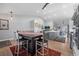 Open-concept kitchen and dining area with island, modern lighting, hardwood floors, and neutral color palette at 2687 E 124Th Pl, Thornton, CO 80241