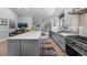 Spacious kitchen with a large island, stainless steel appliances, and plenty of counter space at 2687 E 124Th Pl, Thornton, CO 80241