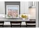 The stylish kitchen sink features a window with a view and modern fixtures at 2687 E 124Th Pl, Thornton, CO 80241