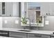 Modern kitchen sink with stainless steel faucet and a bright window view at 2687 E 124Th Pl, Thornton, CO 80241