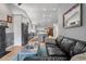 Open concept living room showcasing the kitchen with a view of the front door at 2687 E 124Th Pl, Thornton, CO 80241