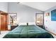This beautiful main bedroom has an airy vibe with its vaulted ceilings and views from the large windows at 2687 E 124Th Pl, Thornton, CO 80241